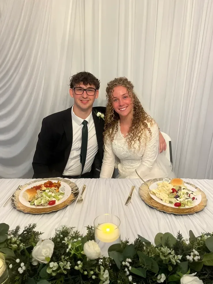 Newlyweds at formal dinner reception