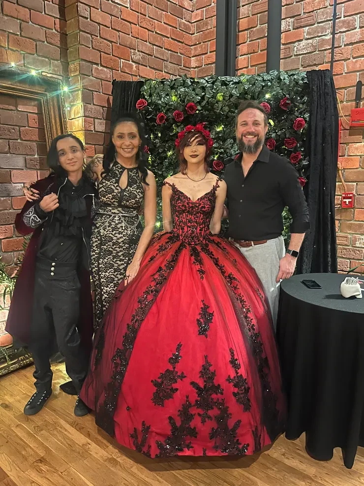Quinceanera celebration with rose wall backdrop