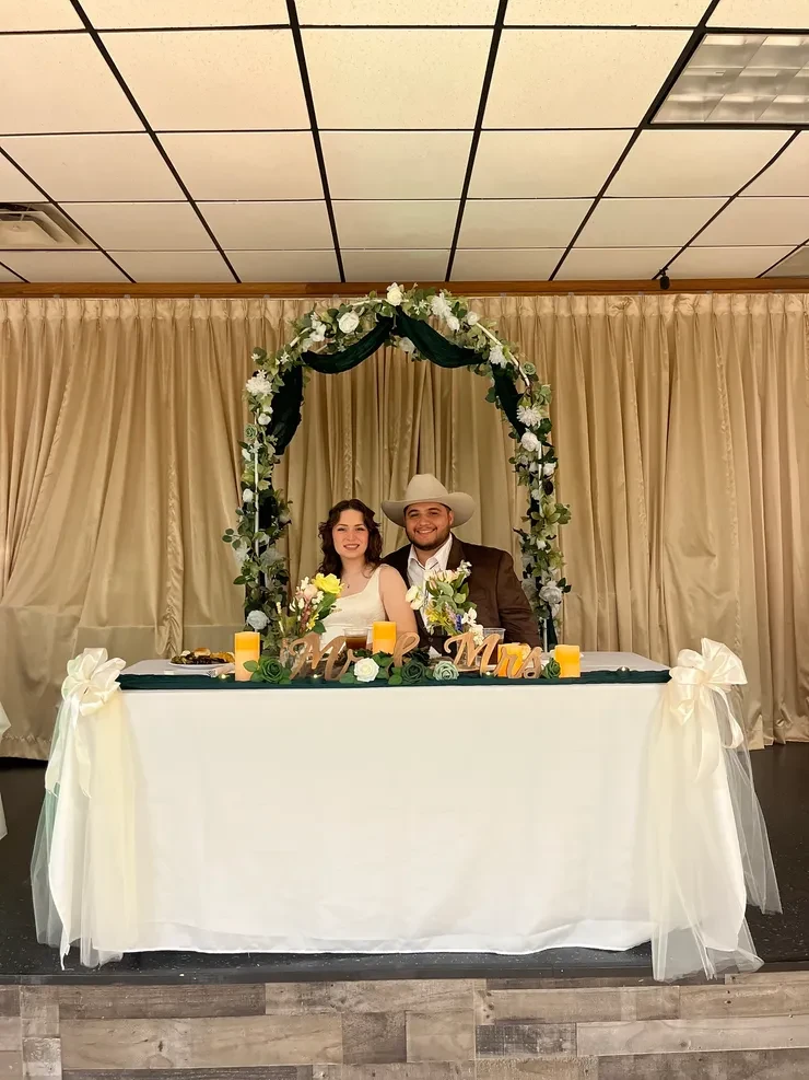 Mr and Mrs sweetheart table with floral arch