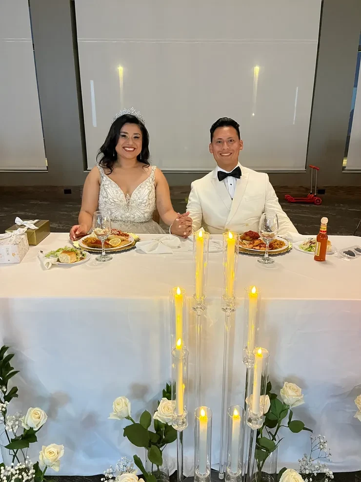 Bride and groom at candlelit sweetheart table