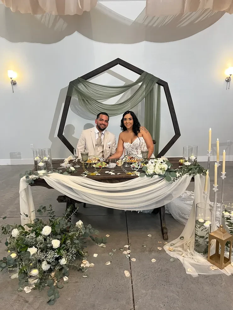 Bride and groom at sweetheart table wedding ceremony