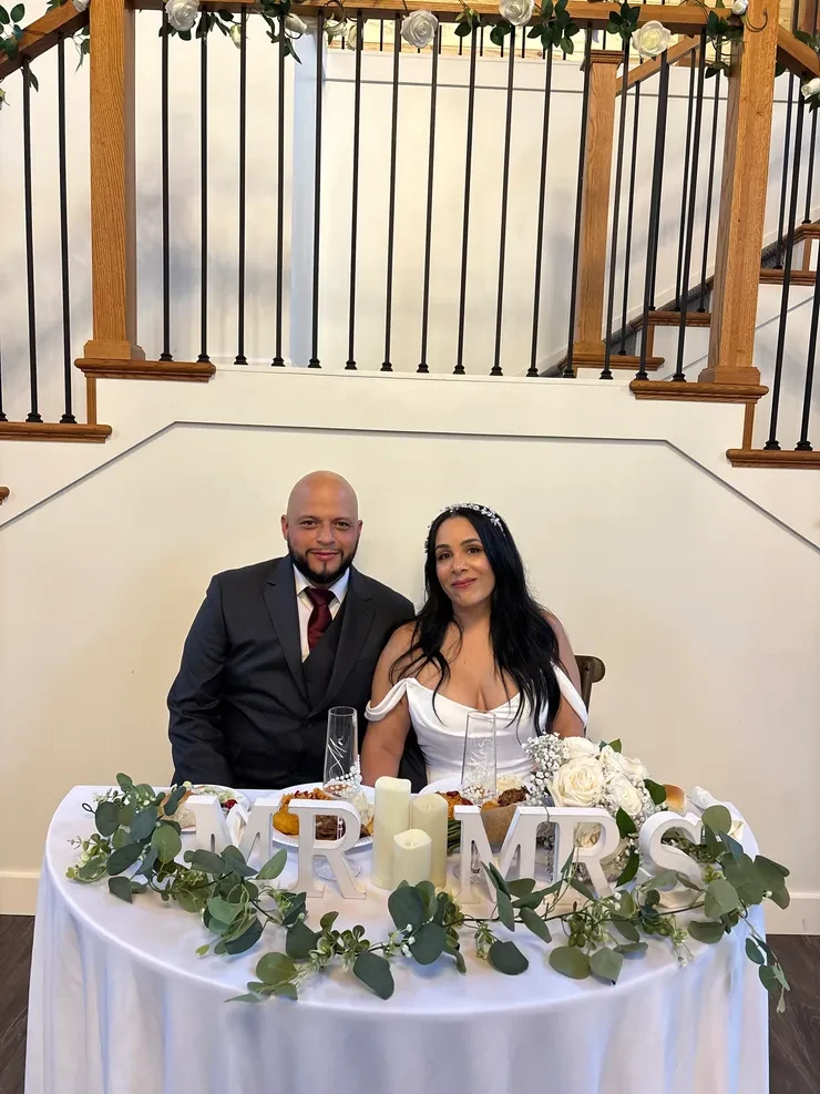 Mr and Mrs sweetheart table with white rose garland staircase