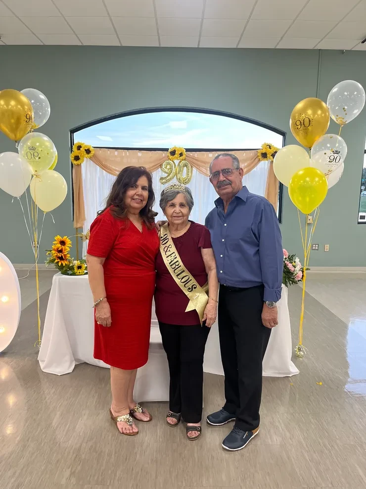 90th birthday celebration with family and gold balloon decorations