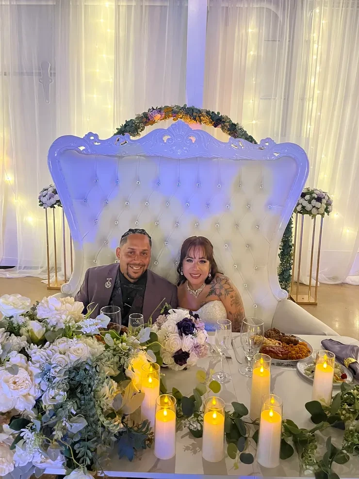 Couple at ornate wedding reception table