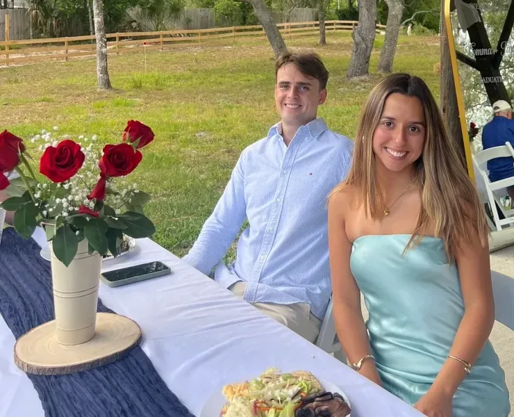 Couple at outdoor wedding reception table