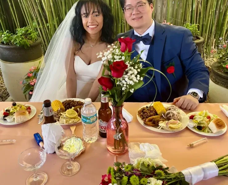 Newlyweds at wedding reception table